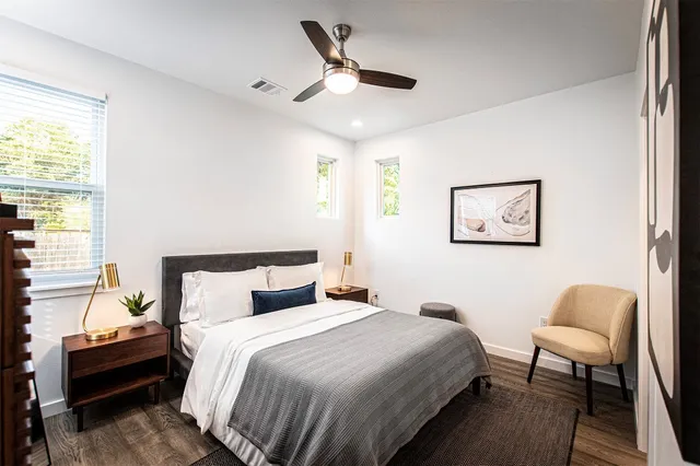 a bathroom with a granite countertop toilet sink and mirror