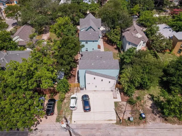an aerial view of multiple houses with outdoor space