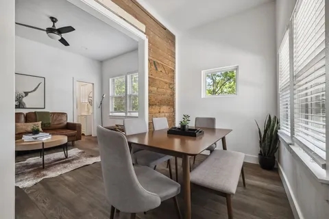 a view of a dining room with furniture window and wooden floor