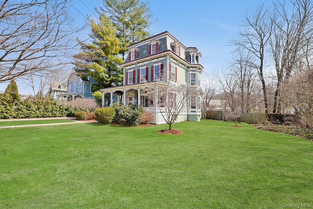 280 Bedford Road Pleasantville, NY 10570 - Photo 4 of 49 a front view of a house with garden and trees