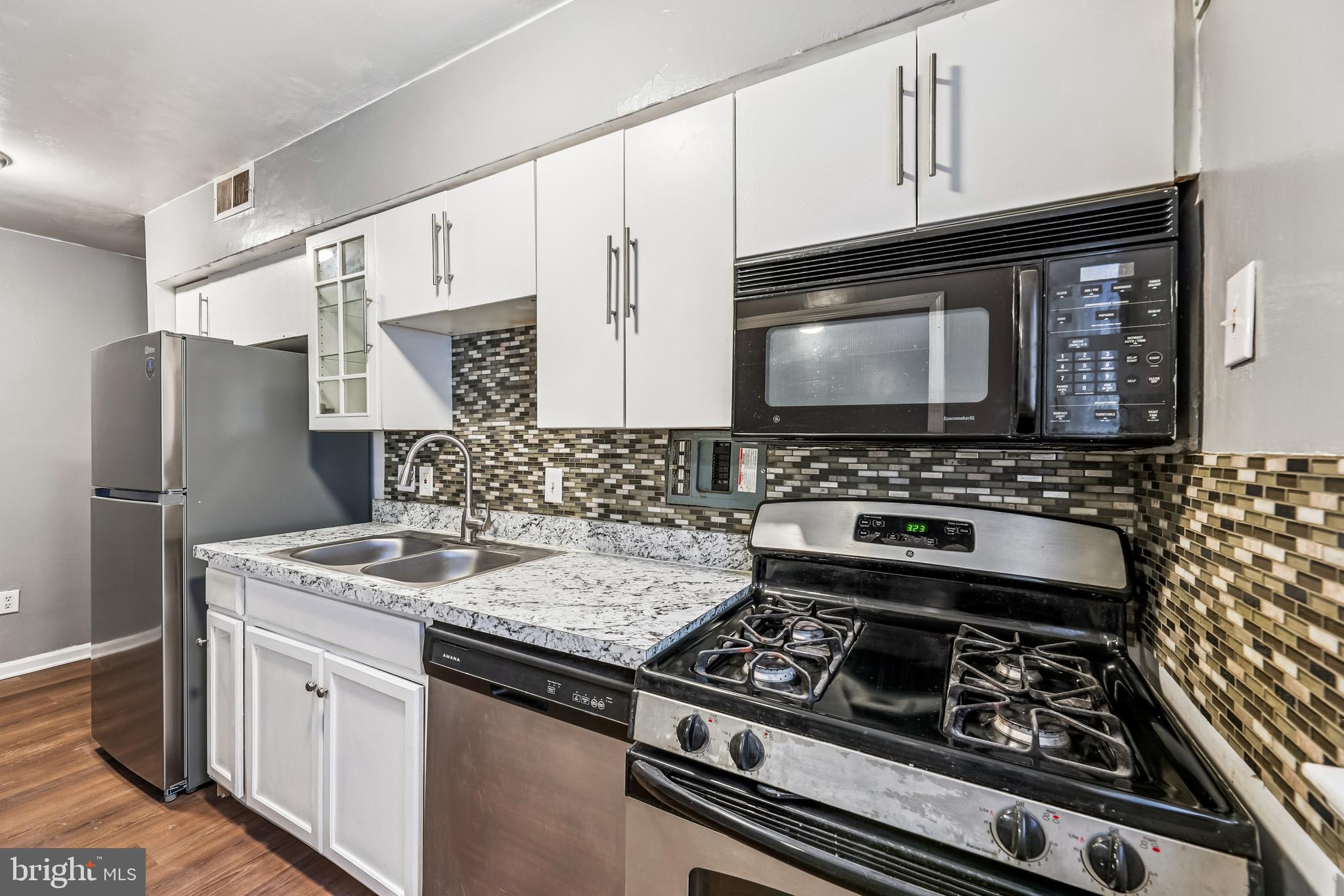 2640 Wade Road Southeast, Unit 2 Washington, DC 20020 - Photo 12 of 23 a kitchen with stainless steel appliances a stove and a microwave