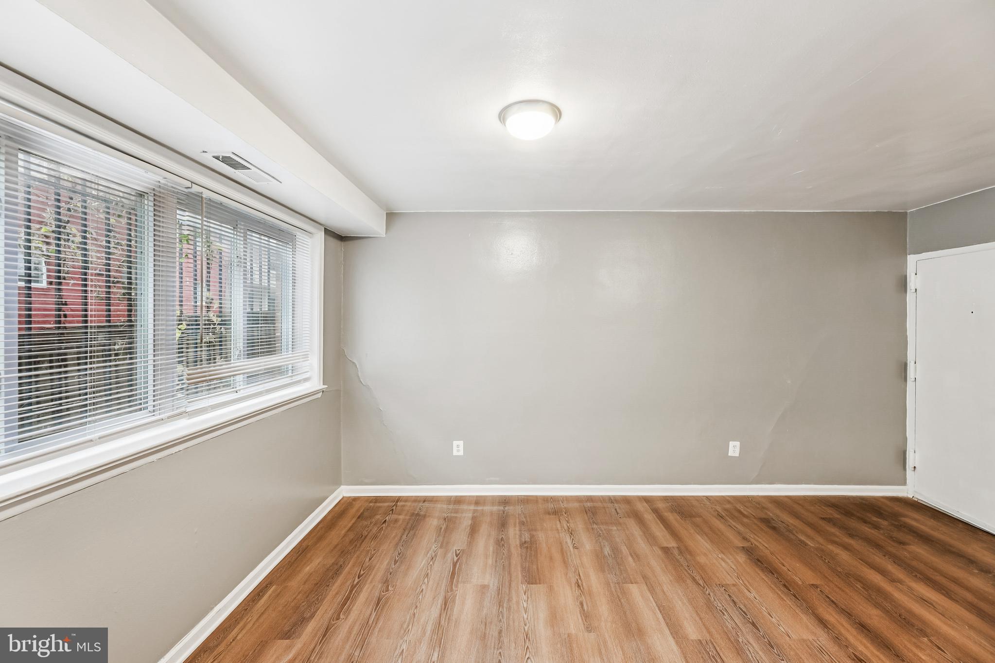 2640 Wade Road Southeast, Unit 2 Washington, DC 20020 - Photo 21 of 23 a view of an empty room with wooden floor and a window
