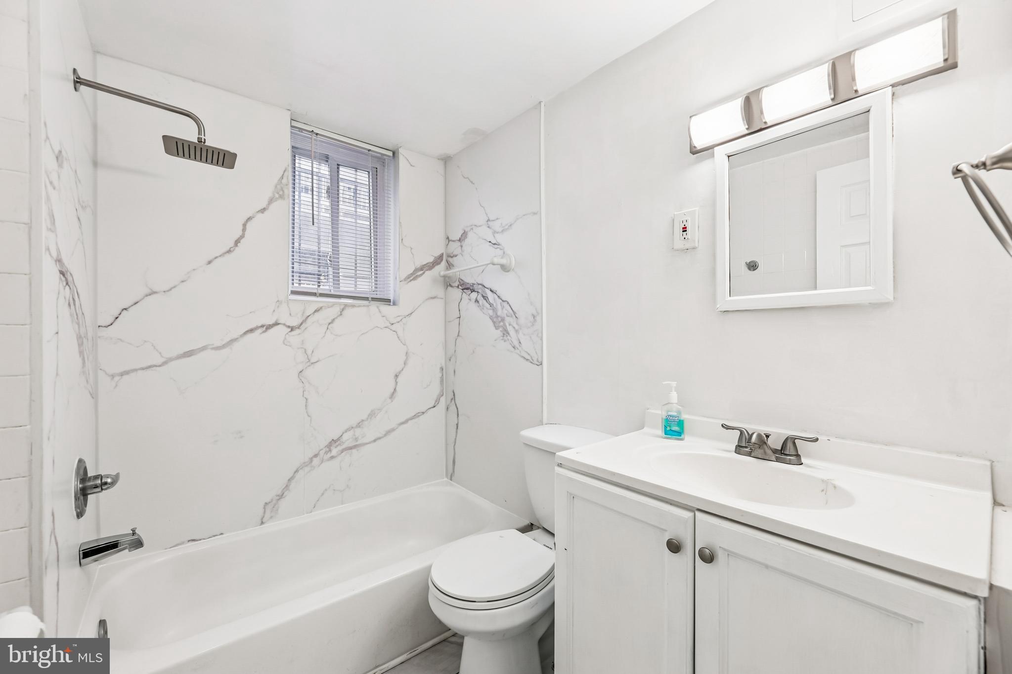2640 Wade Road Southeast, Unit 2 Washington, DC 20020 - Photo 8 of 23 a bathroom with a sink a toilet and a bathtub