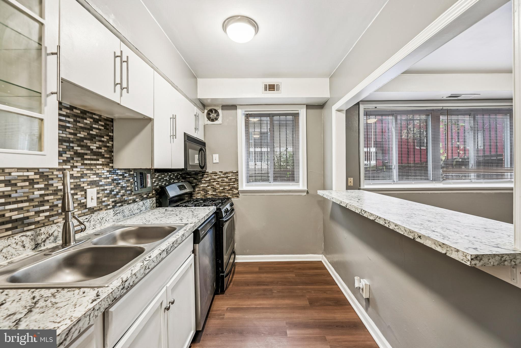 2640 Wade Road Southeast, Unit 2 Washington, DC 20020 - Photo 10 of 23 a kitchen with granite countertop a sink and a stove
