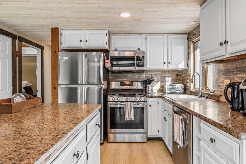 110 Kelley Road Hyannis, MA 02601 - Photo 11 of 30 a kitchen with stainless steel appliances granite countertop a sink stove and refrigerator