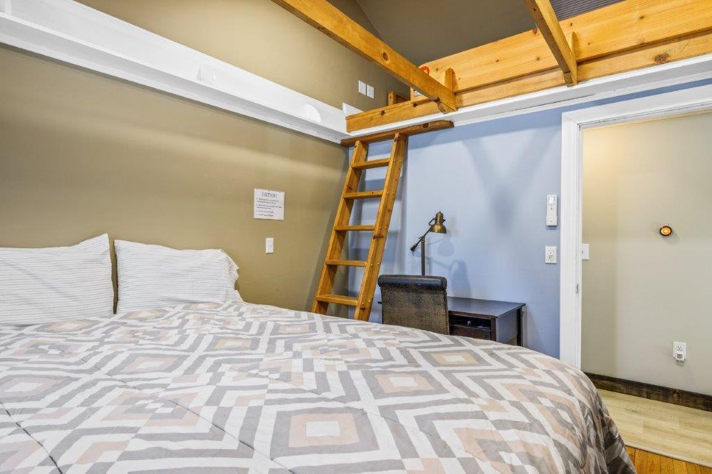 110 Kelley Road Hyannis, MA 02601 - Photo 19 of 30 a bedroom with a large bed and a chandelier