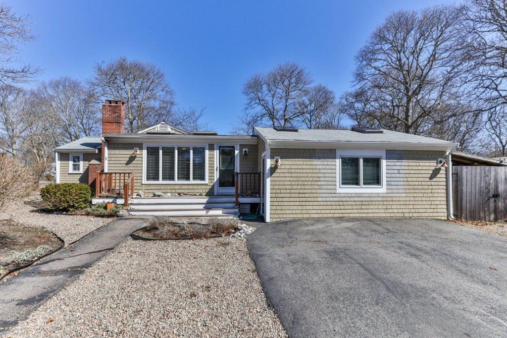 110 Kelley Road Hyannis, MA 02601 - Photo 28 of 30 a view of a white house with large windows next to a road