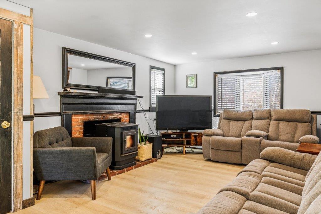 110 Kelley Road Hyannis, MA 02601 - Photo 3 of 30 a living room with furniture a flat screen tv and a fireplace