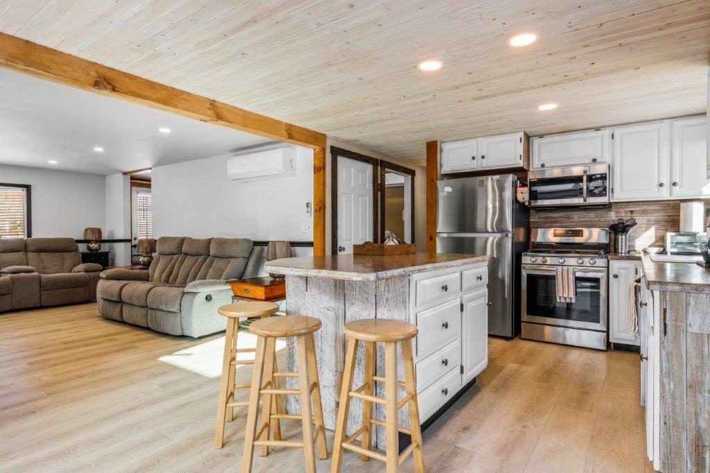 110 Kelley Road Hyannis, MA 02601 - Photo 9 of 30 a large kitchen with stainless steel appliances kitchen island granite countertop a refrigerator and a stove top oven