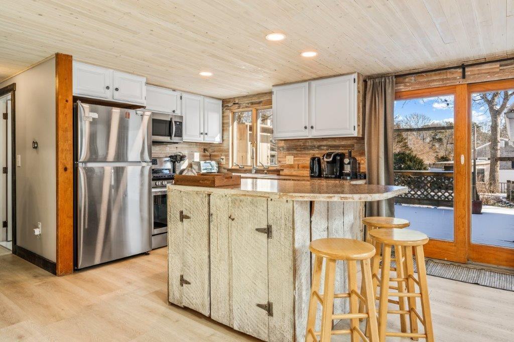 110 Kelley Road Hyannis, MA 02601 - Photo 10 of 30 a kitchen with stainless steel appliances granite countertop a refrigerator and a stove top oven