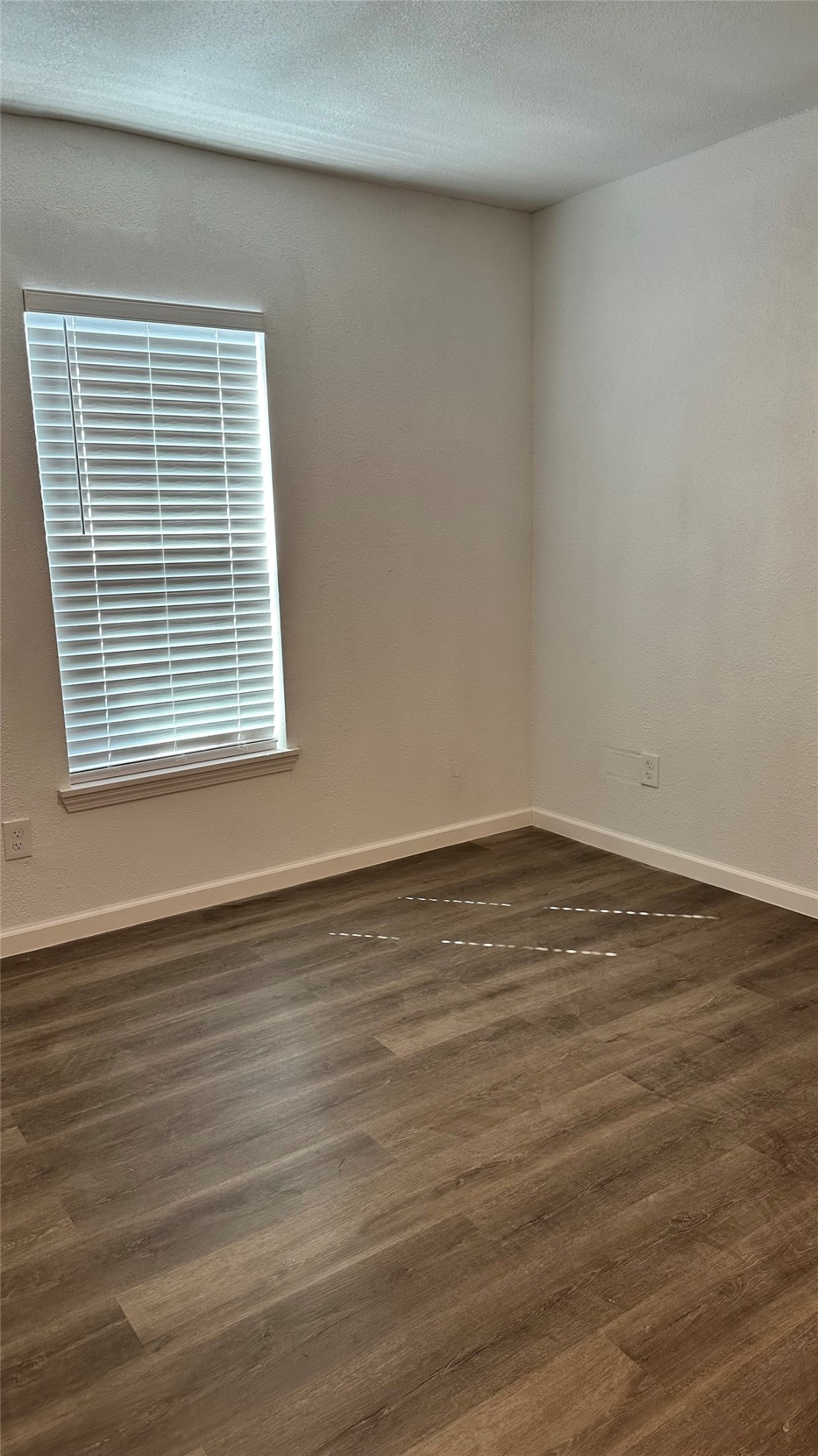 6200 Ranchester Drive, Unit 230 Houston, TX 77036 - Photo 19 of 31 a view of an empty room with wooden floor and a window