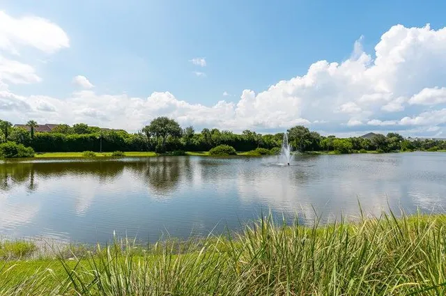 a swimming pool with outdoor seating and yard