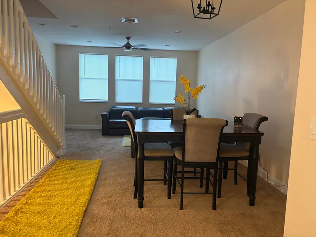 a dining room with furniture and window