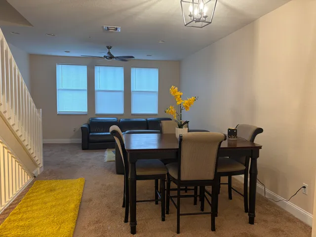 a view of a dining room with furniture and a chandelier