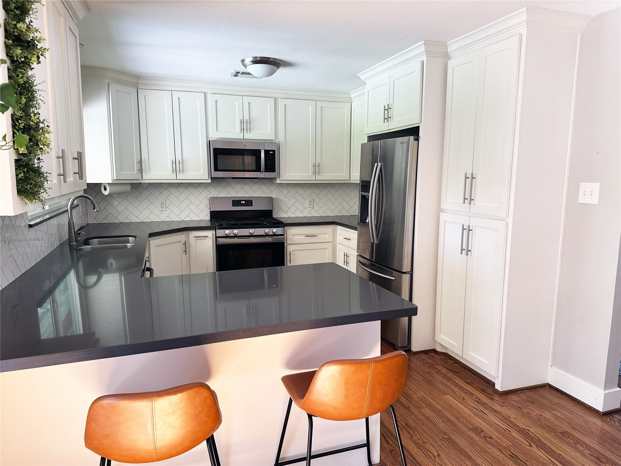 4821 Hummingbird Street Houston, TX 77035 - Photo 7 of 45 a kitchen with stainless steel appliances granite countertop a stove a refrigerator and a microwave