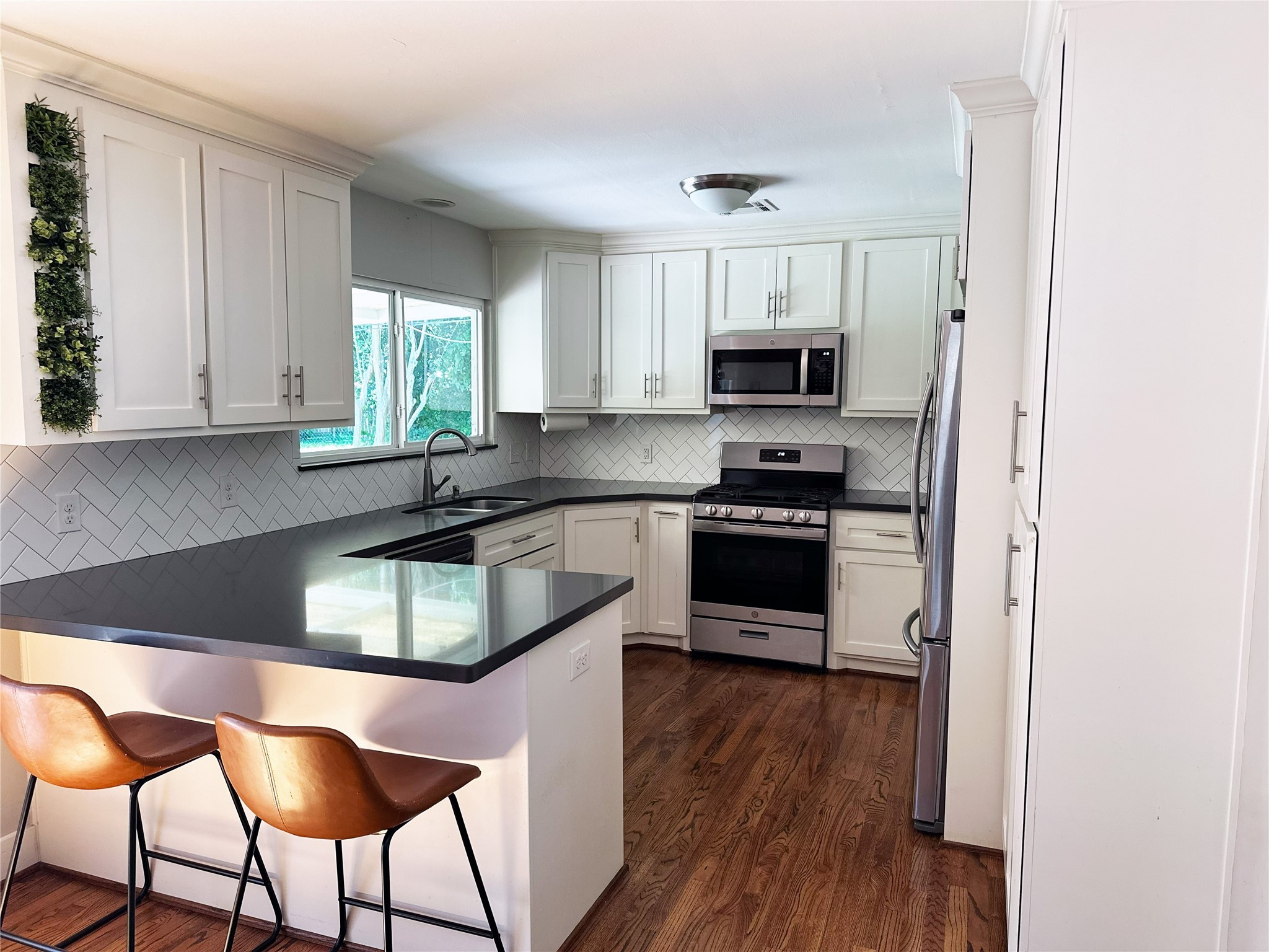 4821 Hummingbird Street Houston, TX 77035 - Photo 8 of 45 a kitchen with granite countertop a stove a sink and a refrigerator
