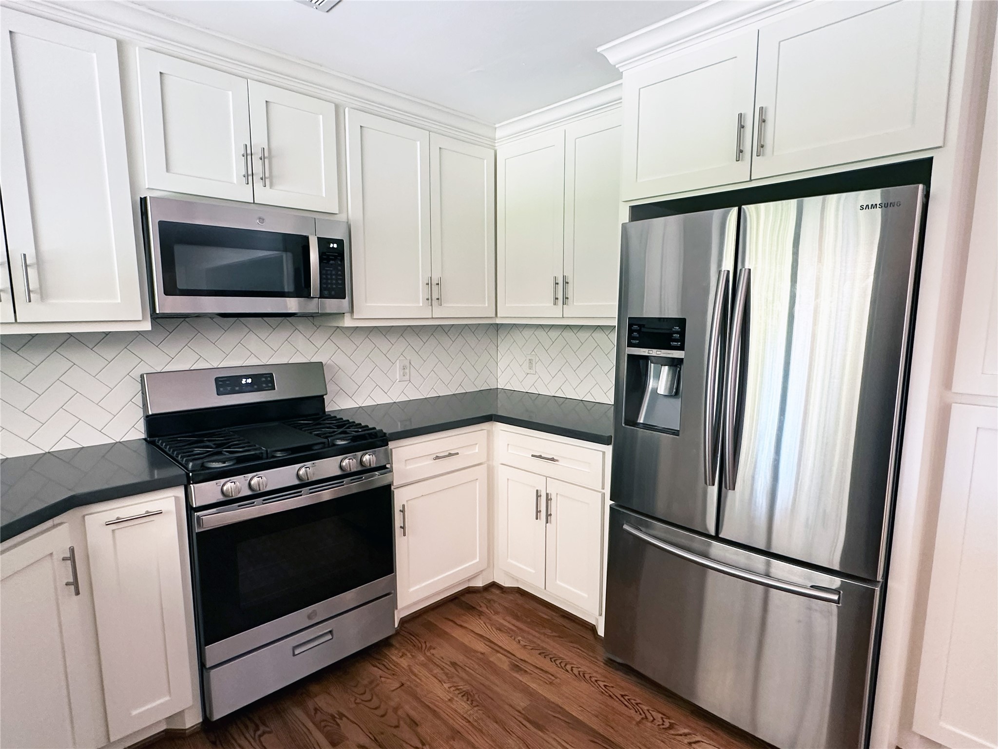 4821 Hummingbird Street Houston, TX 77035 - Photo 10 of 45 a kitchen with cabinets stainless steel appliances and wooden floor