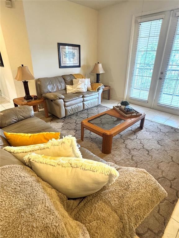 3051 Greystone Loop, Unit 306 Kissimmee, FL 34741 - Photo 13 of 27 a living room with furniture and a table