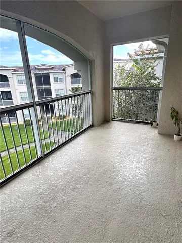 a view of an empty room with windows