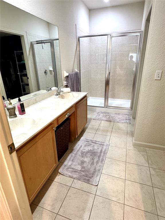 3051 Greystone Loop, Unit 306 Kissimmee, FL 34741 - Photo 19 of 27 a bathroom with a sink a mirror and a shower