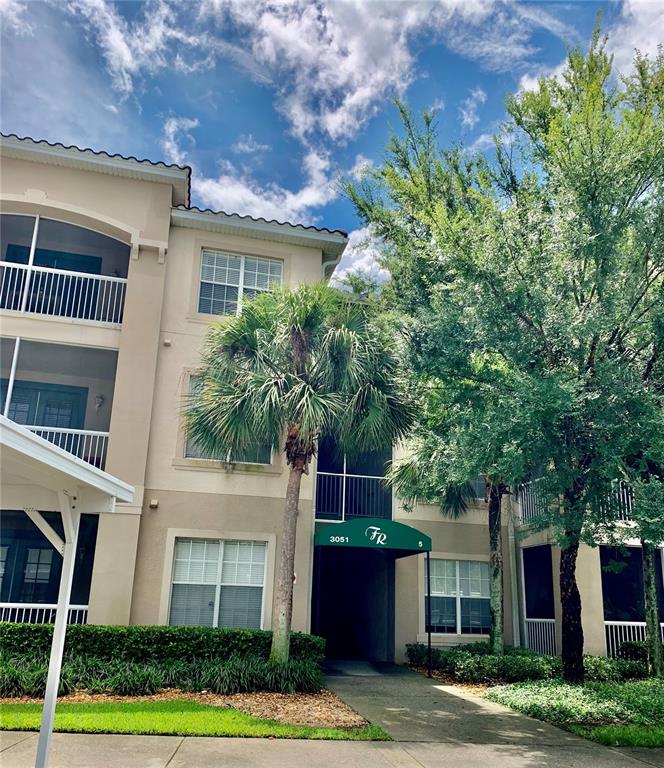 3051 Greystone Loop, Unit 306 Kissimmee, FL 34741 - Photo 2 of 27 a front view of a house with garden