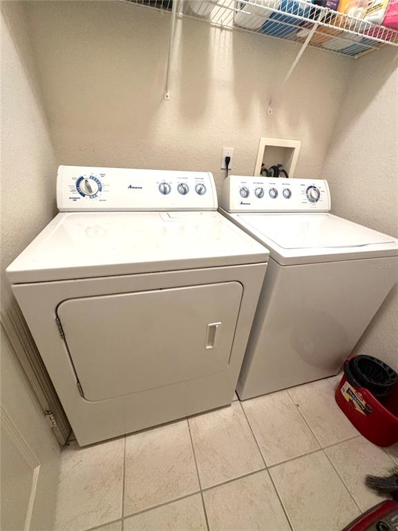 3051 Greystone Loop, Unit 306 Kissimmee, FL 34741 - Photo 23 of 27 a utility room with dryer and washer