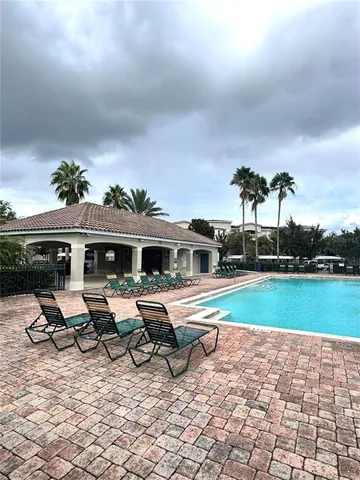 a view of a house with swimming pool and sitting area