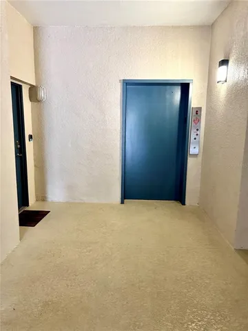 an empty room with closet and mirror