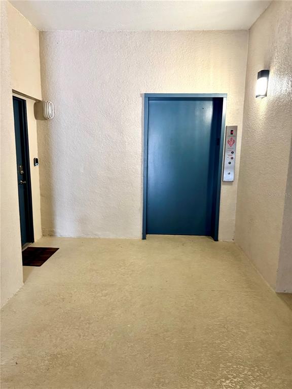 3051 Greystone Loop, Unit 306 Kissimmee, FL 34741 - Photo 5 of 27 an empty room with closet and mirror