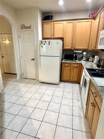 a kitchen with a stove a refrigerator and a sink