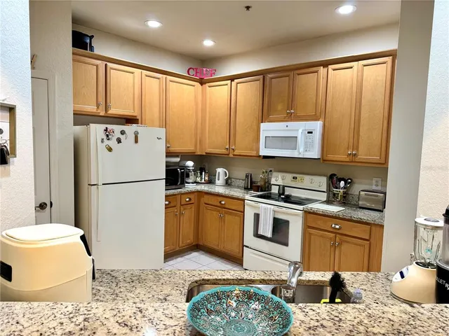 a kitchen with a refrigerator sink and stove