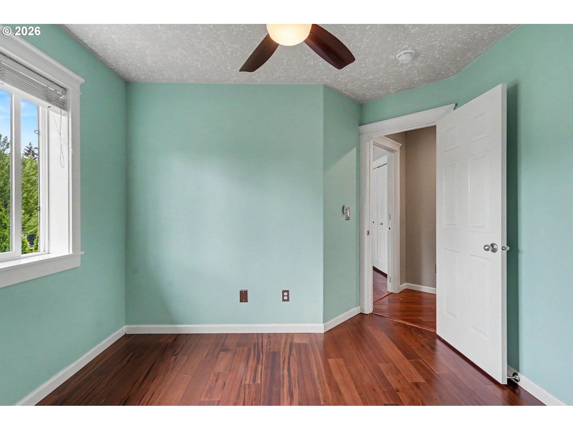 1462 Barnick Road Northeast Keizer, OR 97303 - Photo 35 of 48 a view of an empty room with wooden floor and a window