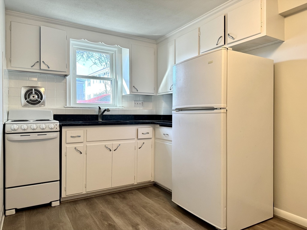 206 High Street, Unit 7 Waltham, MA 02453 - Photo 1 of 17 a white refrigerator freezer sitting inside of a kitchen