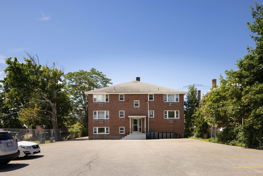 206 High Street, Unit 7 Waltham, MA 02453 - Photo 17 of 17 a front view of a house with a yard