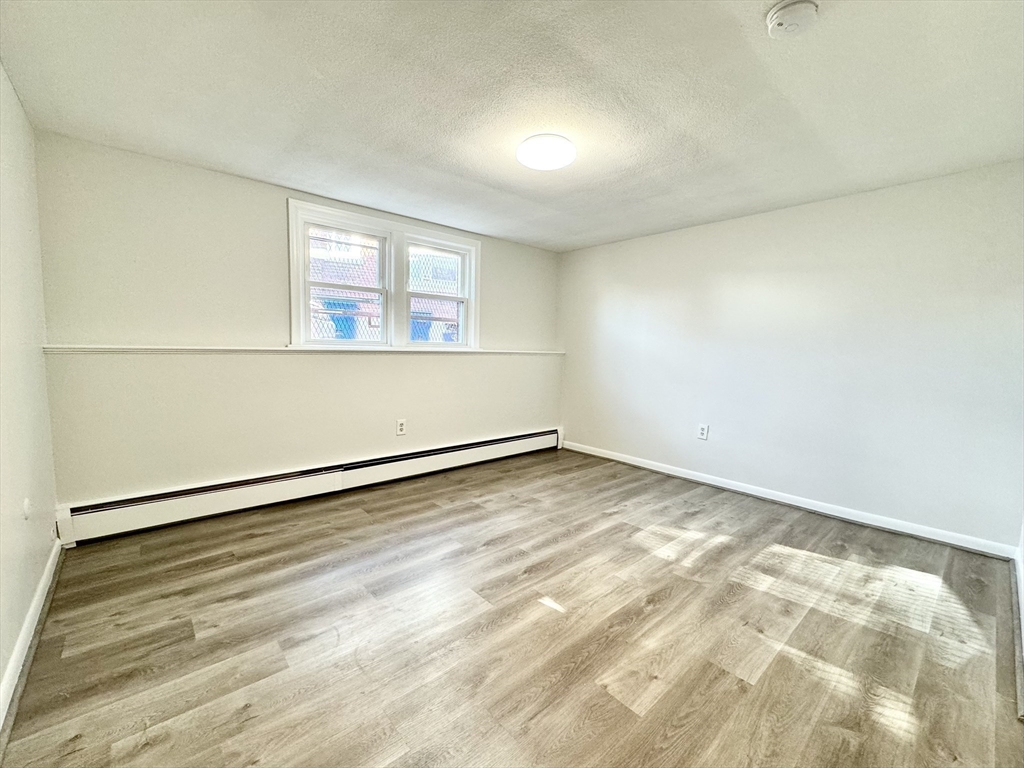 206 High Street, Unit 7 Waltham, MA 02453 - Photo 6 of 17 an empty room with a workbench