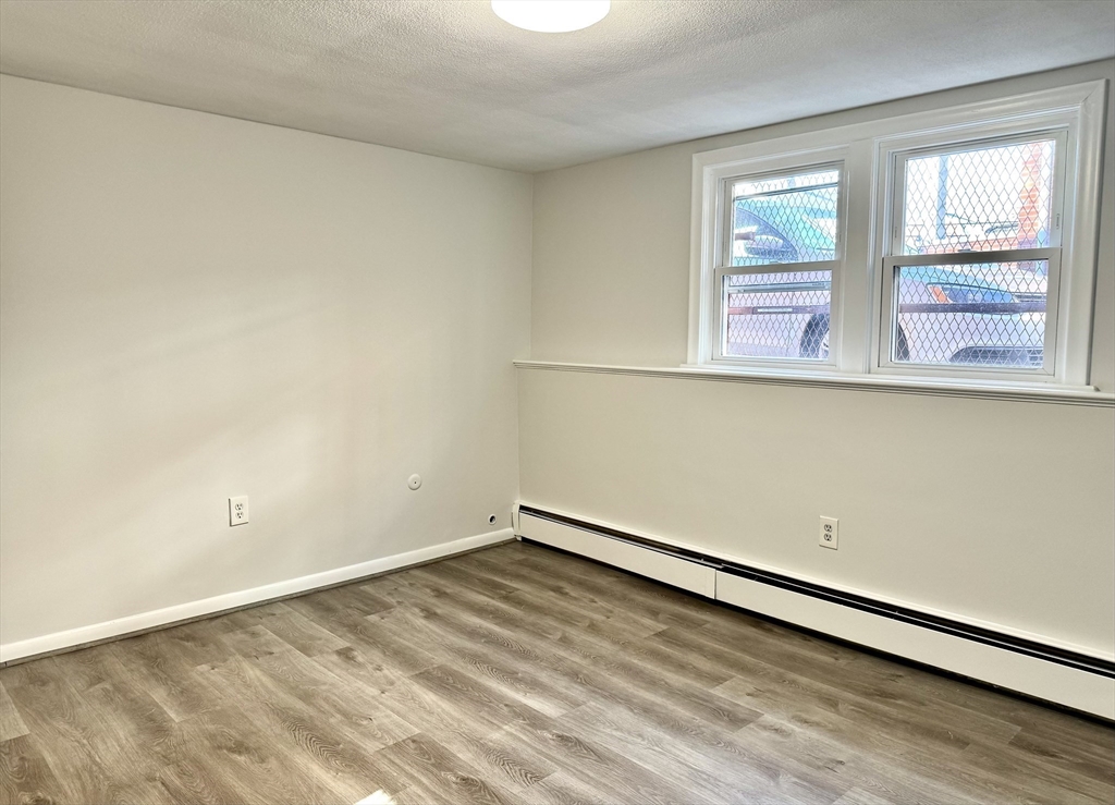 206 High Street, Unit 7 Waltham, MA 02453 - Photo 9 of 17 an empty room with windows