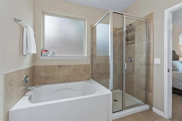 a bathroom with a bathtub and a shower