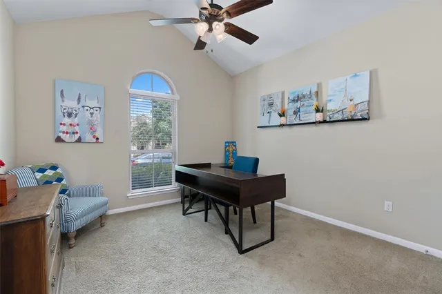 a view of a workspace with furniture and a window