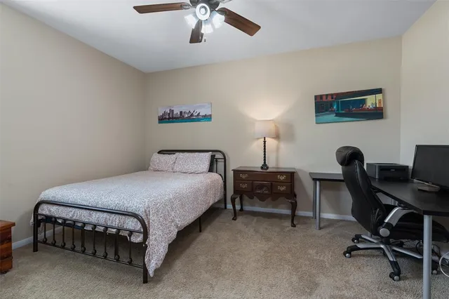 a bedroom with a bed a desk and chair
