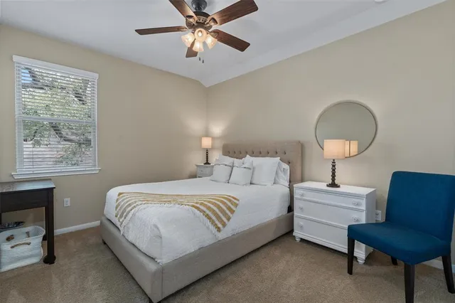 a bedroom with a bed a couch and a window