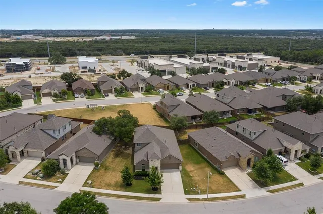 an aerial view of residential houses with outdoor space