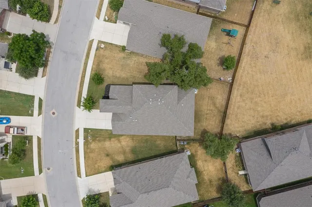 an aerial view of a house with a yard
