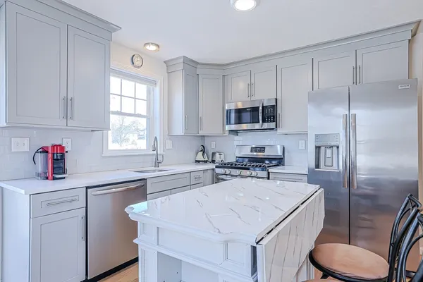 a kitchen with a sink stove and refrigerator