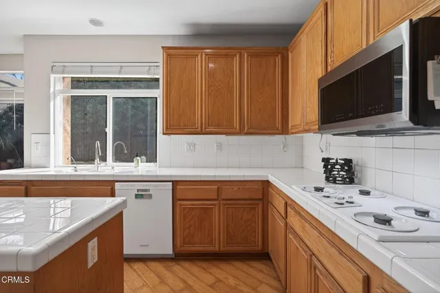 a kitchen with a sink stove and microwave