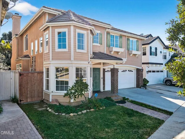 a front view of a house with a yard and porch