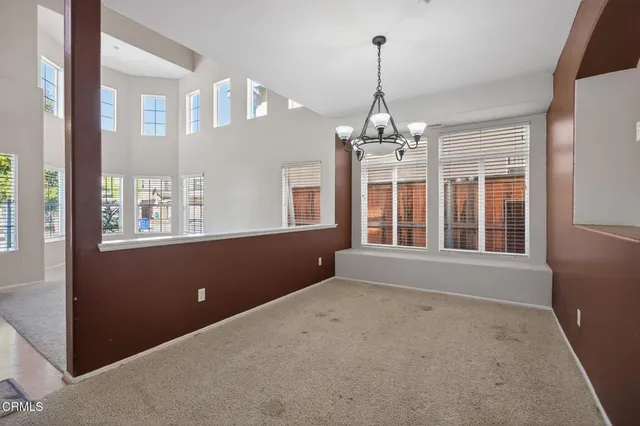 a very nice looking room with a large window and chandelier