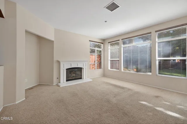 an empty room with furniture and a fireplace