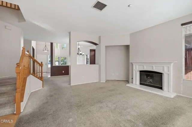 a view of a livingroom with an empty space and a fireplace