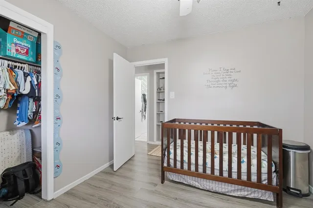 a view of hallway with wooden floor and closet
