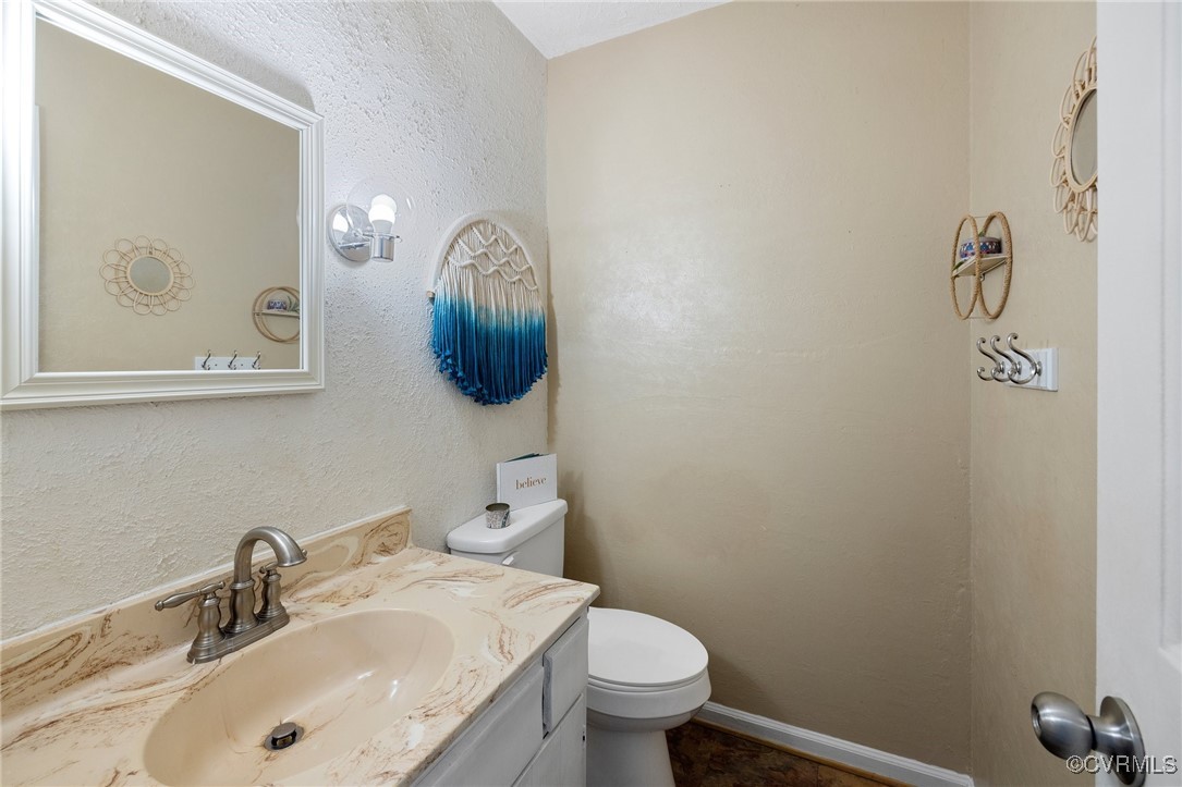 1908 Early Settlers Road Richmond, VA 23235 - Photo 14 of 25 a bathroom with a sink and a mirror
